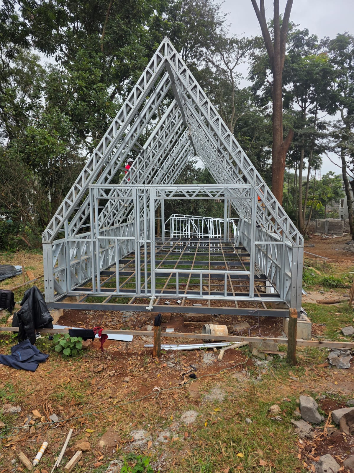 Steel-framed A-Frame cabin under construction, viewed from the gable end