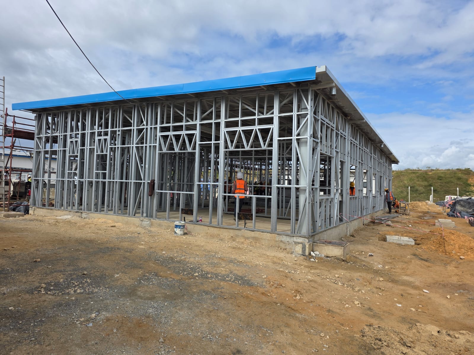 Light gauge steel commercial building under construction with blue roof sheeting